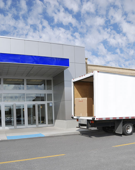 commercial removals truck loading in front a building